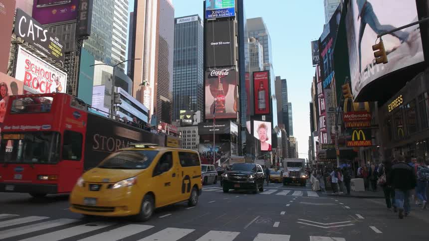 Traffic and bicyclists travel down a city street