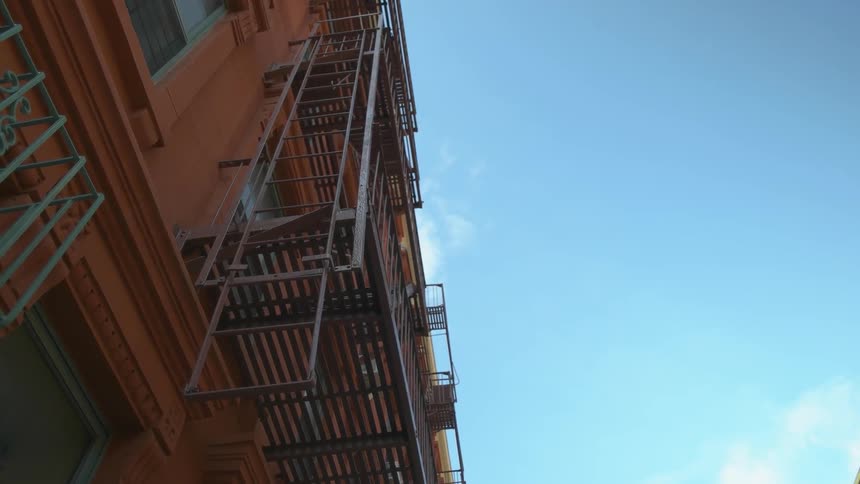 A fire escape is attached to an apartment building