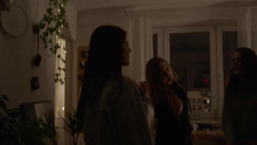 A group of women dance in an apartment