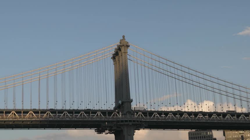 Vehicles slowly drive over the bridge ahead