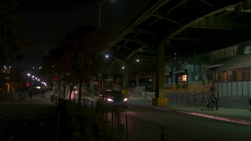 Vehicles commute down a city street at night