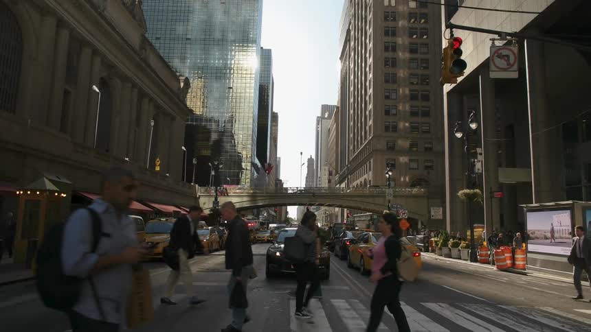 The busy city street have many people crossing the street