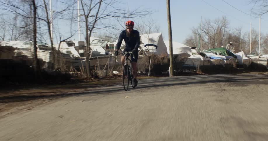 A man rides a bicycle down the road