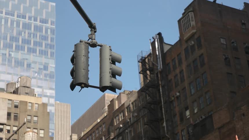 A traffic light downtown in a big city