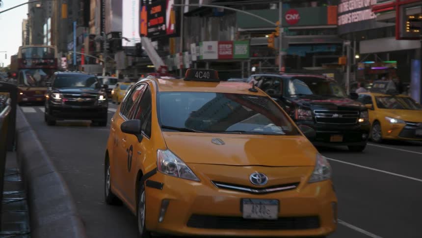 Pedestrians and vehicles commute through the city
