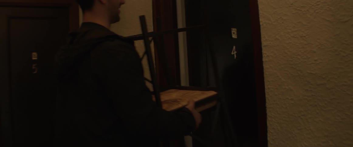 Group of friends carry furniture into new apartment