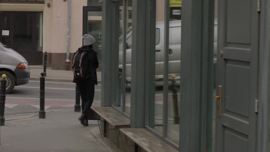 A woman enters a city building