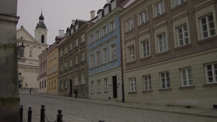 People are walking in the distance of this city block