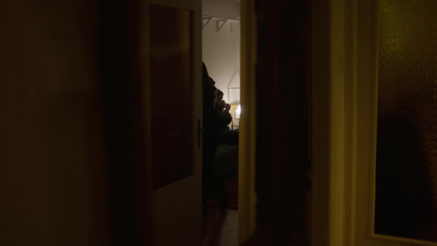 Two people dancing in a living room