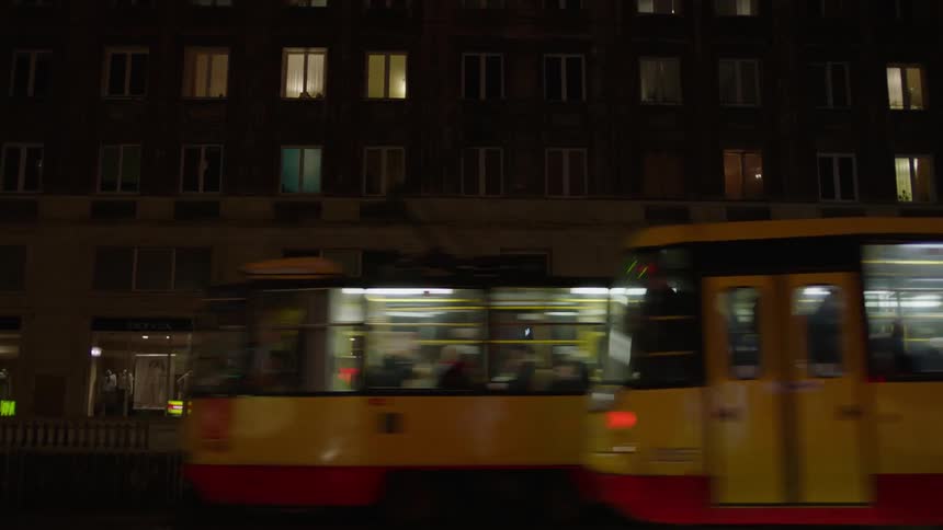 Vehicles travel on a city street at night