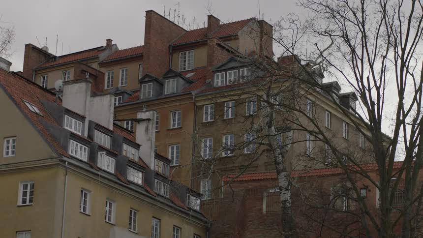 Large building with many windows sits under a cloudy sky