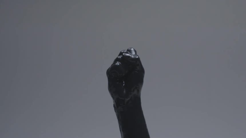 A hand covered in latex clinches in a fist
