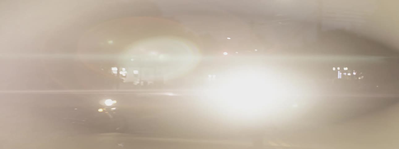 Man riding a motorcycle followed by another motorcycle at night