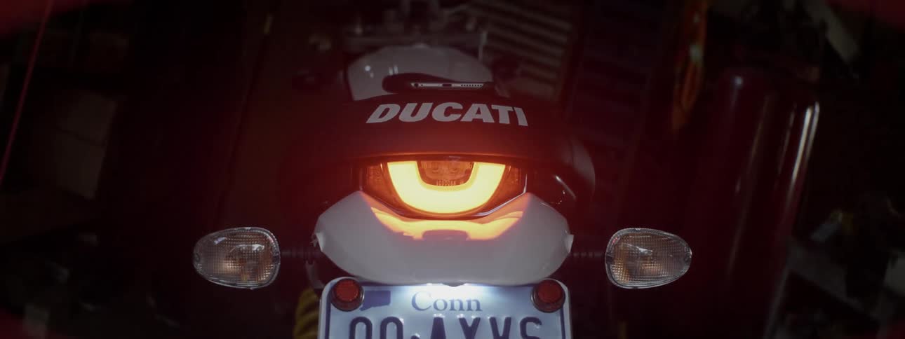 A ducati bike's headlight shines