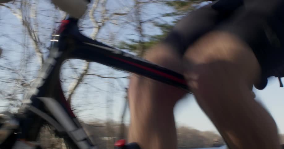 A man rides his bike fast down the trail