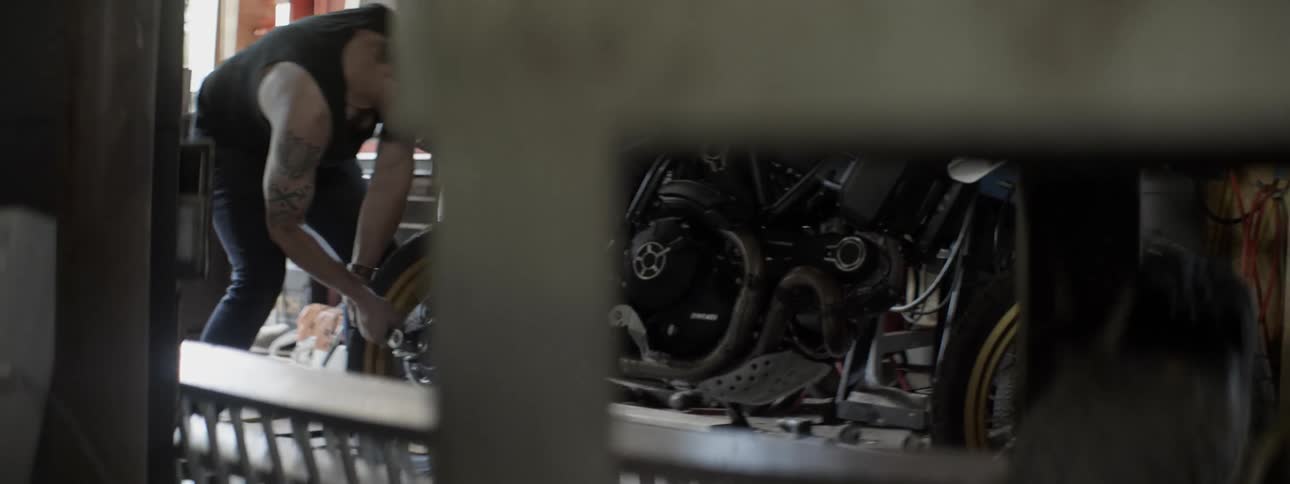 Man works on a motorcycle in a garage