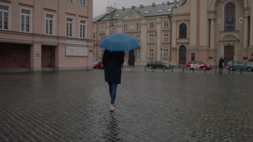 People walk in the city as it rains