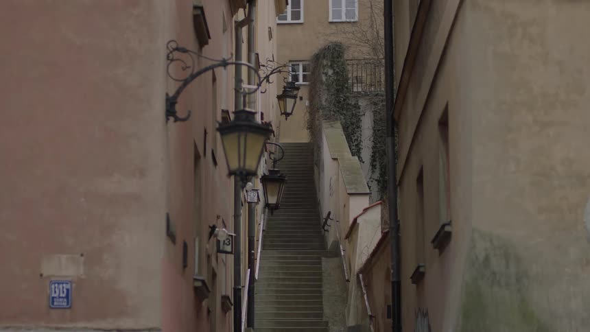 The alley is empty leading to the staircase