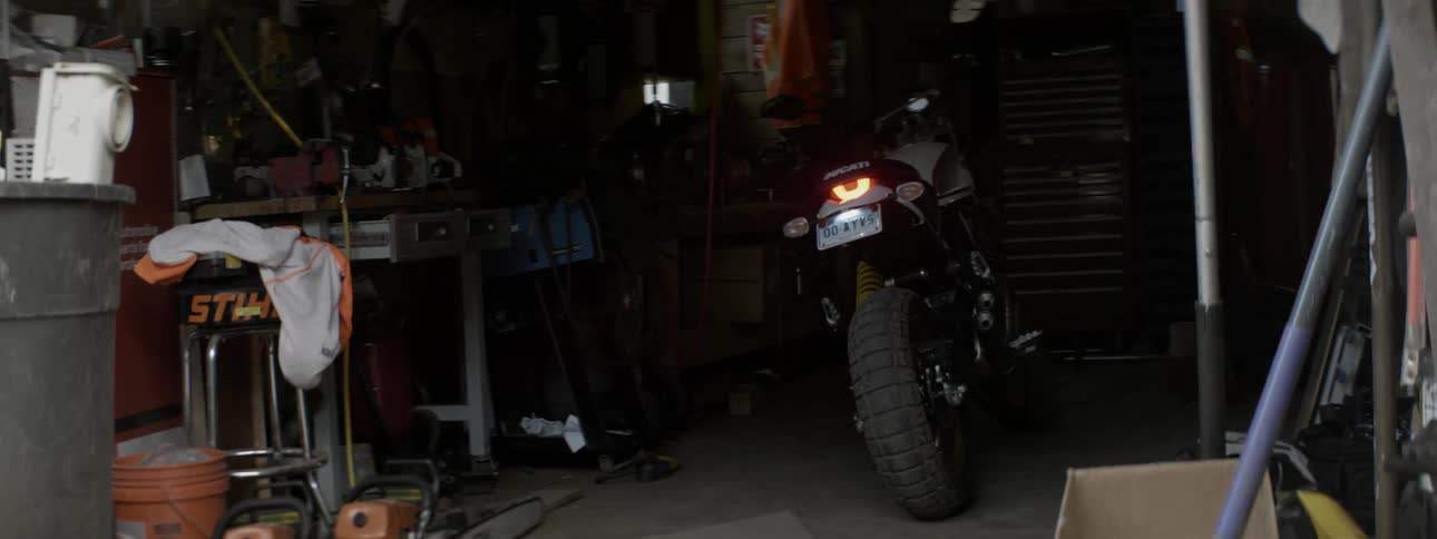 A motorcycle is running inside a garage
