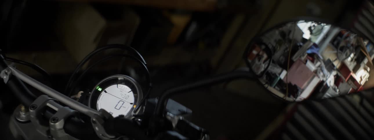 Motorcycle odometer showing zero in a garage