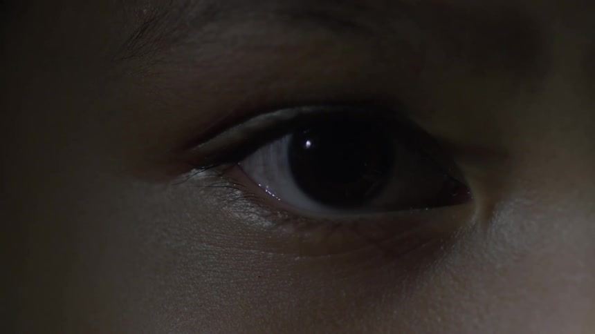 A person stares forward blinking only once