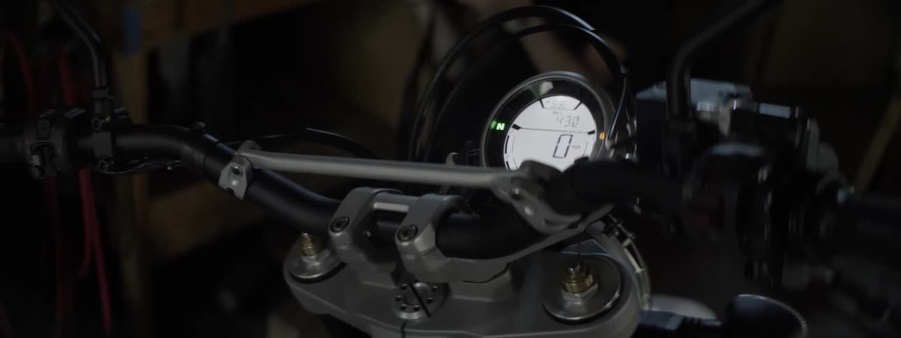 A digital odometer is displayed on a motorcycle