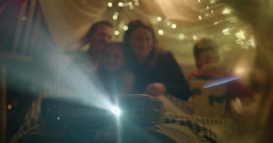 A family watch a projector together