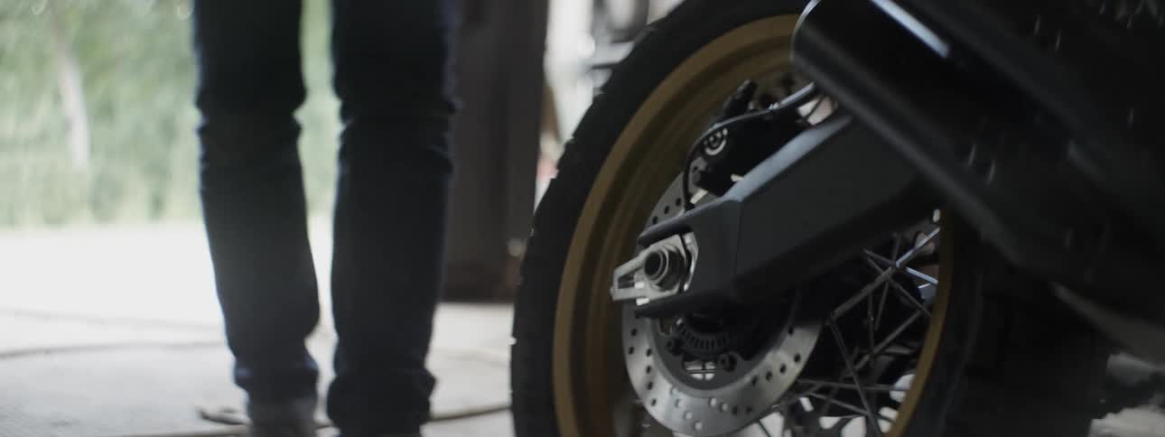 A man walks over to his motorcycle