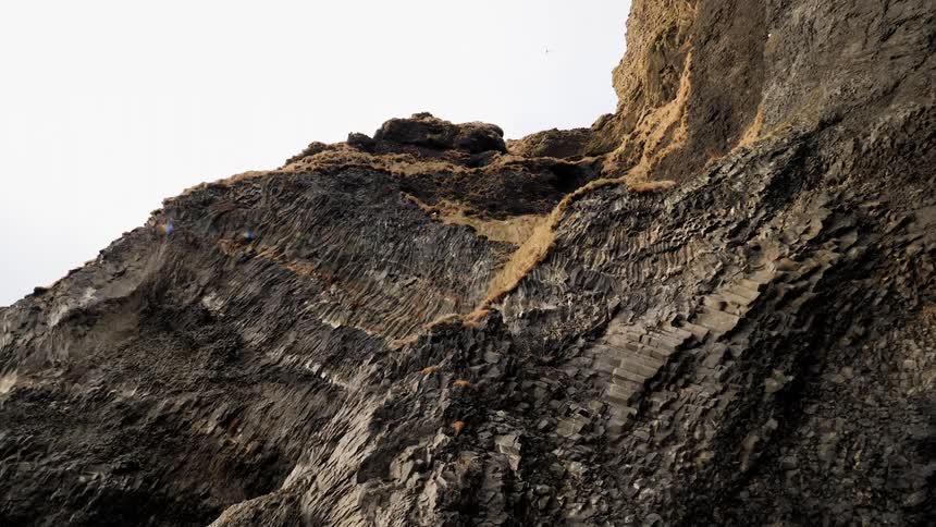 Birds soaring above a rocky cliff