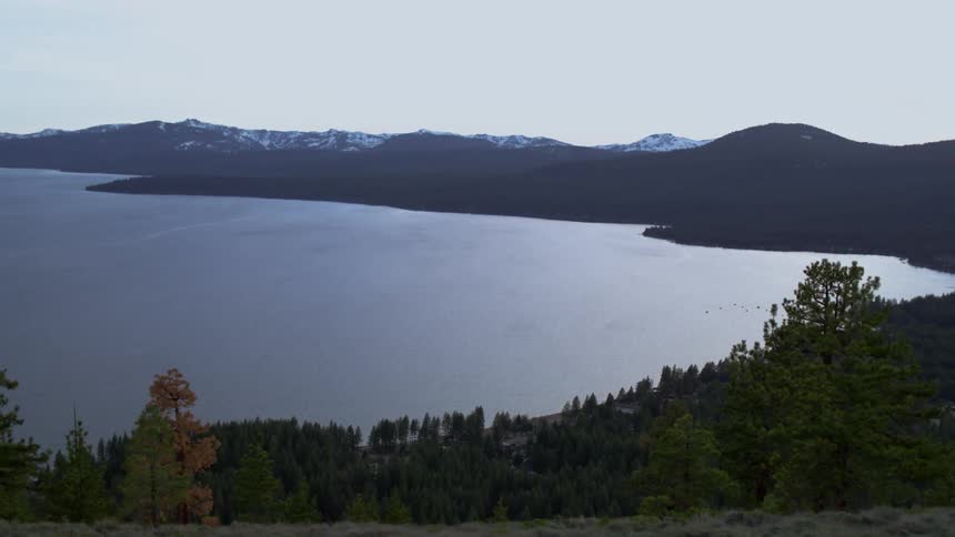 A ridge overlooks the trees and water below
