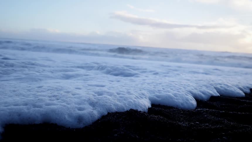 Foamy waves wash onto the shore