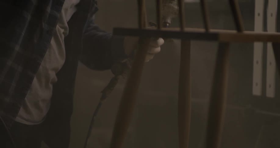 A man is working on building a chair