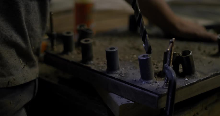 Muses uses drill on piece of metal