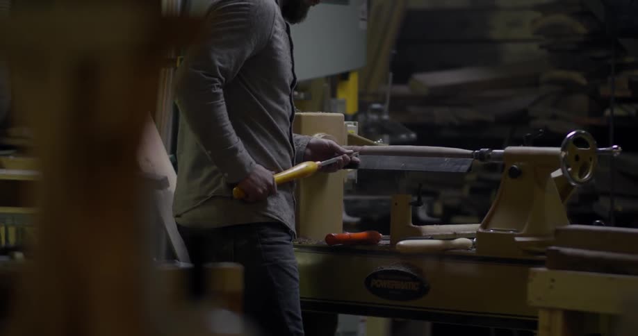 A carpenter works in a shop