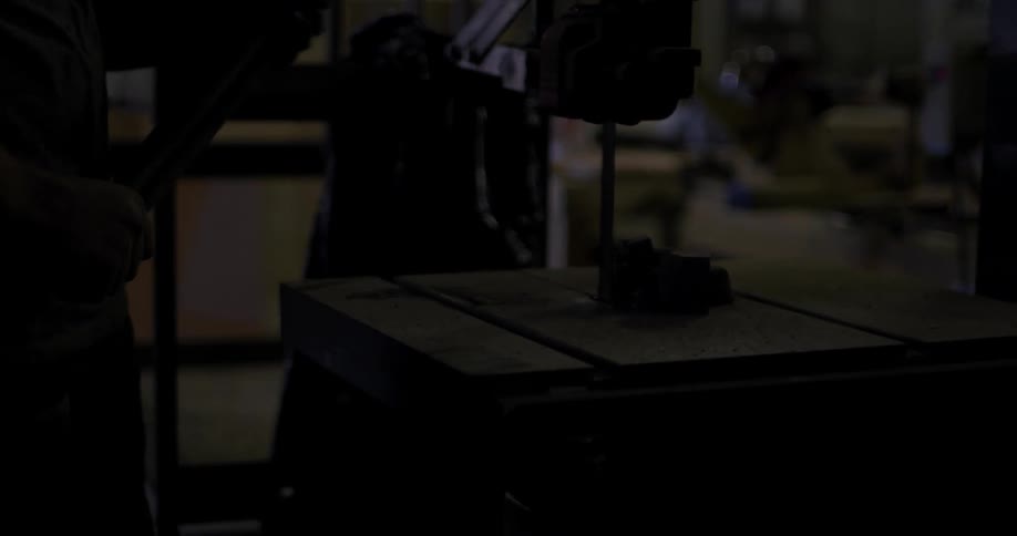A person is working in a shop using a machine