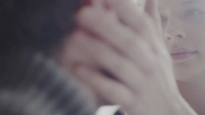 Close up of woman touching a man's face