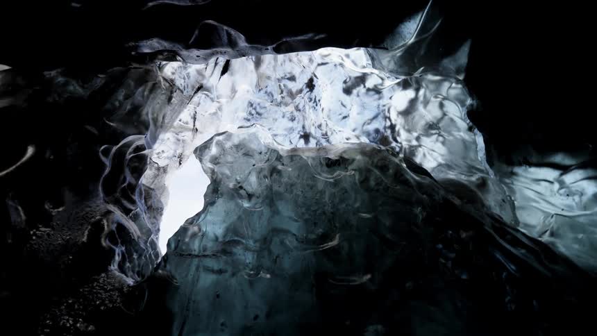 Light shines through ice and rock formations