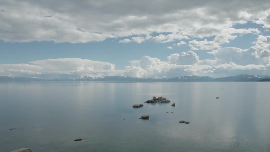 Soaring forward over small rock islands large body of water