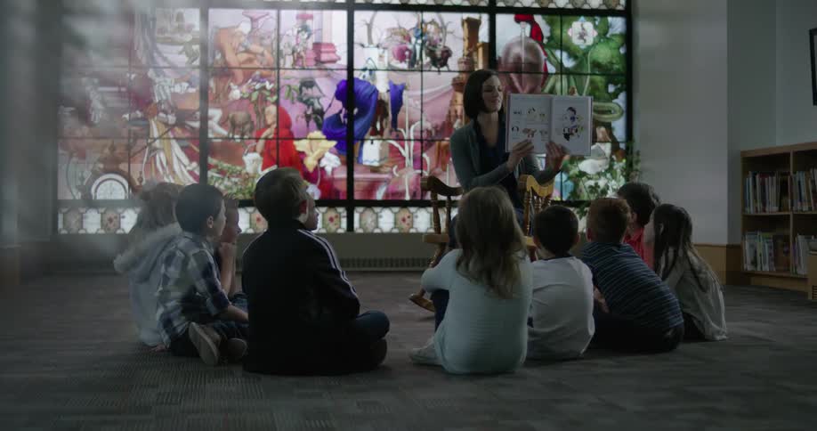 A woman reads to a group of children
