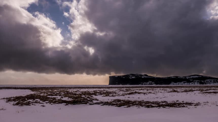 Clouds passing over a snowy landscape