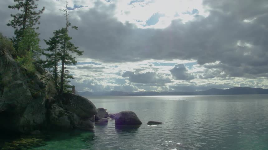 Water flows gently on the shore of a lake