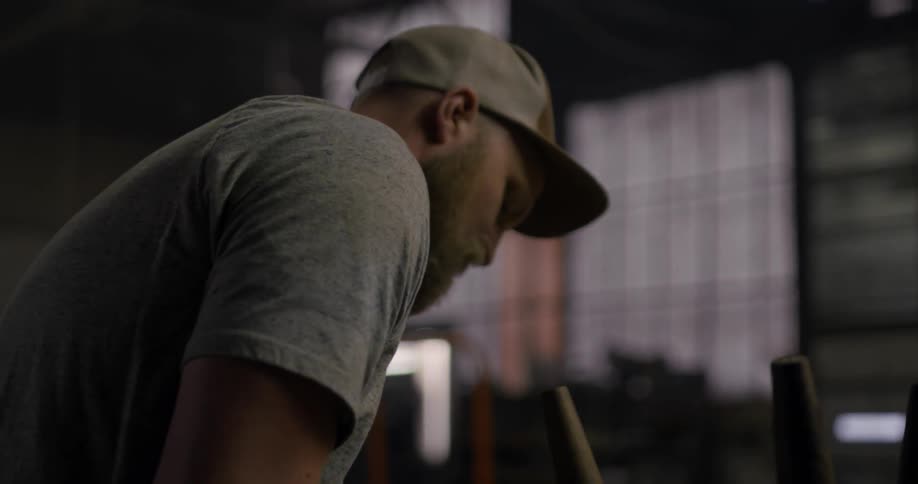 A man works on a chair in a workshop