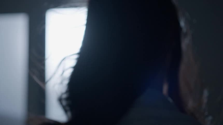 A woman's long hair blows in the breeze
