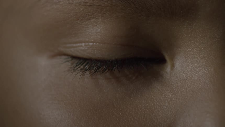 A person opens their eye