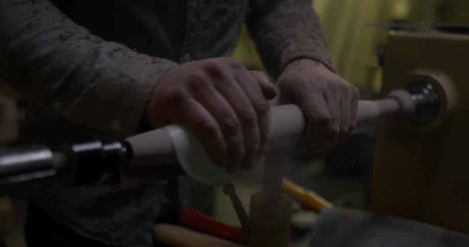 A man polishes a piece of wood