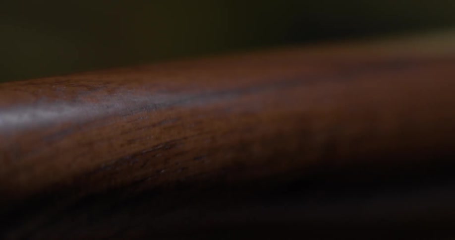 A round piece of dark wood spins