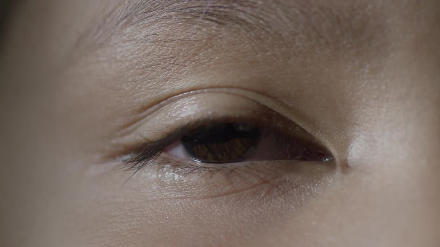 A person opens their eyes slowly