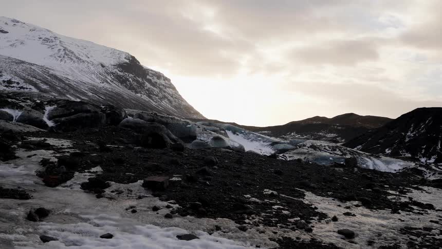 Snow covered mountains under a cloudy sky