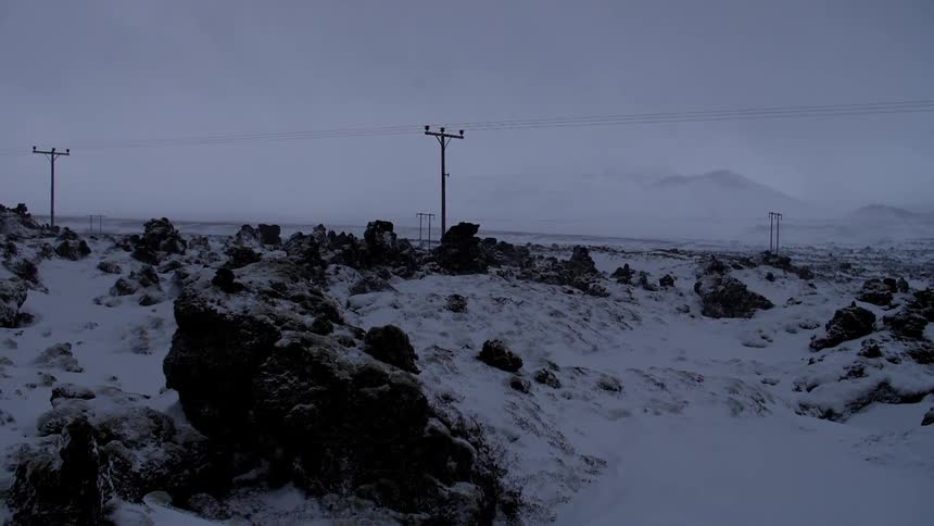 The rocks are covered with ice near these power lines