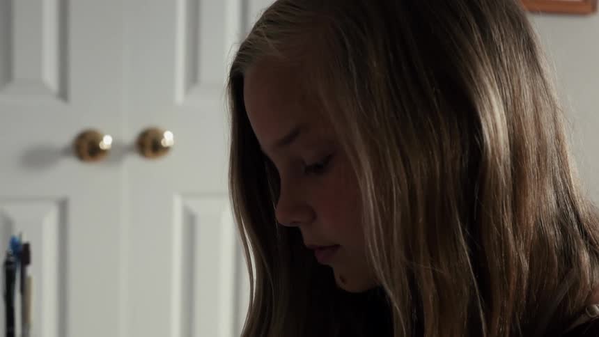 A girl sits at a desk